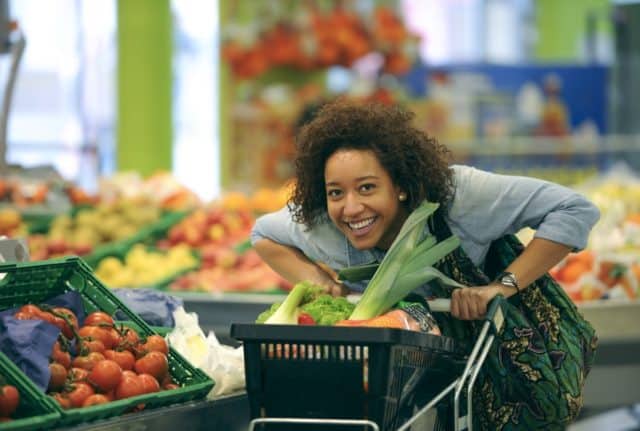 Happy woman shopping for vegetables
