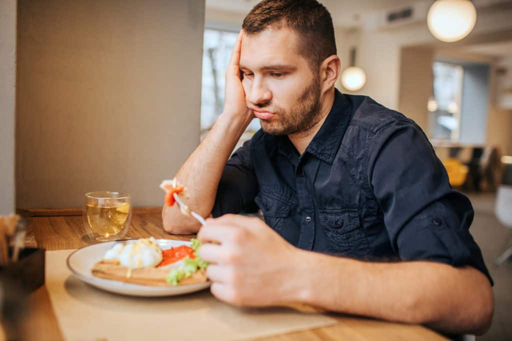 Man looks bored with his dinner