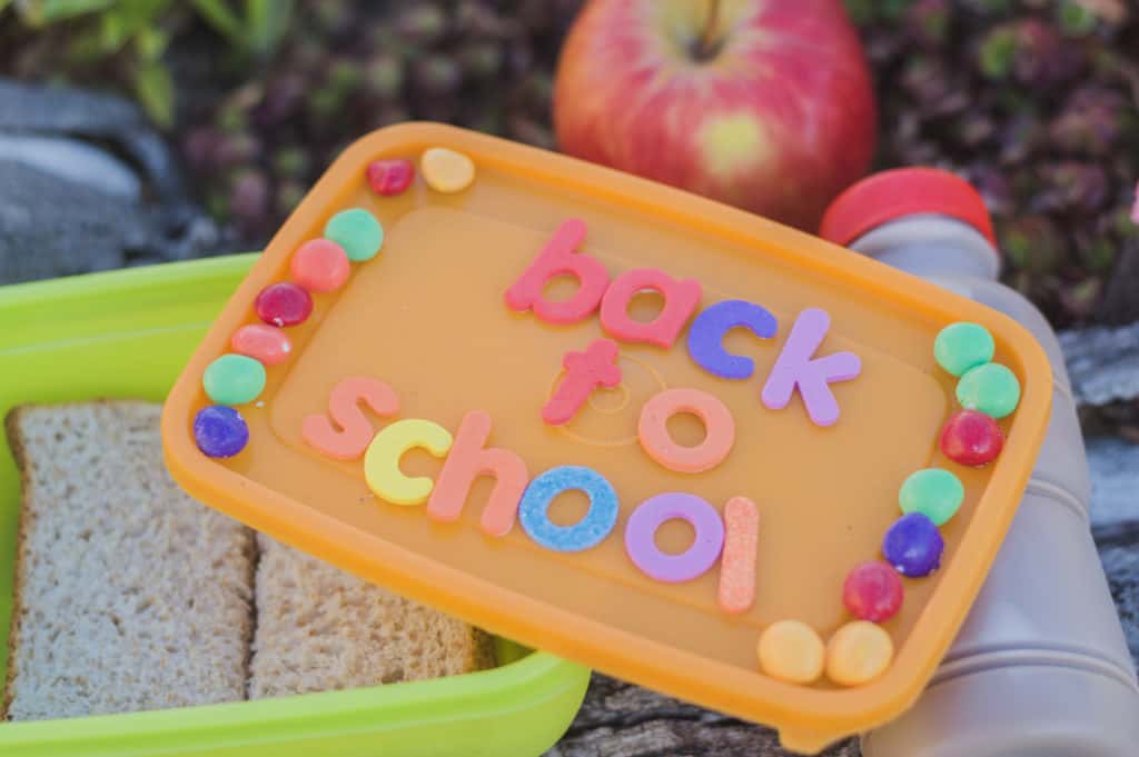 back to school written in colorful letters on a lunchbox