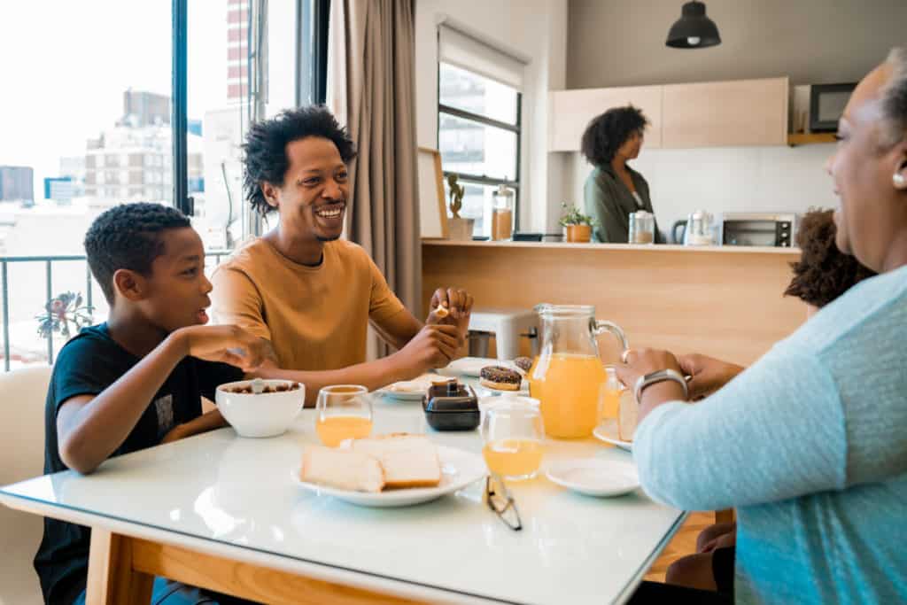 Happy family eating a fun weekend breakfast together.