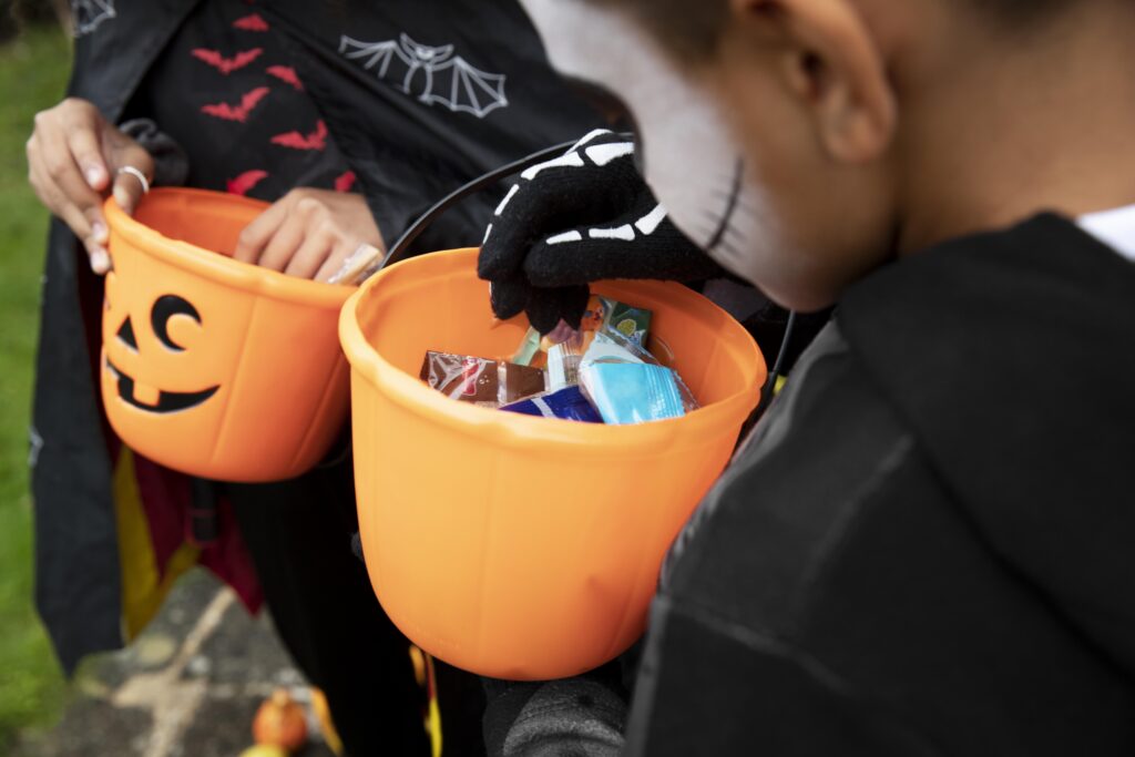 Kids holding their trick-or-treat buckets for Halloween