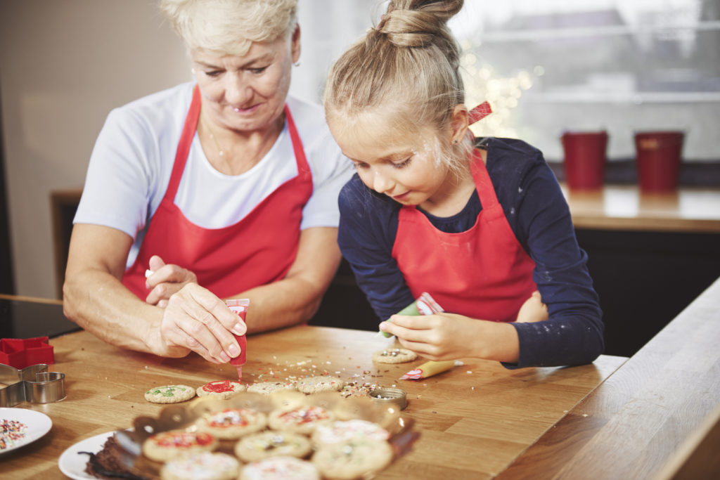 Grandchild with Grandma Baking Holiday Cookies
