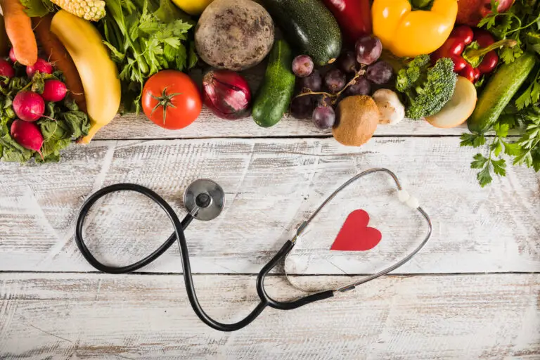 elevated-view-stethoscope-with-heart-shape-near-fresh-vegetables-wooden-desk